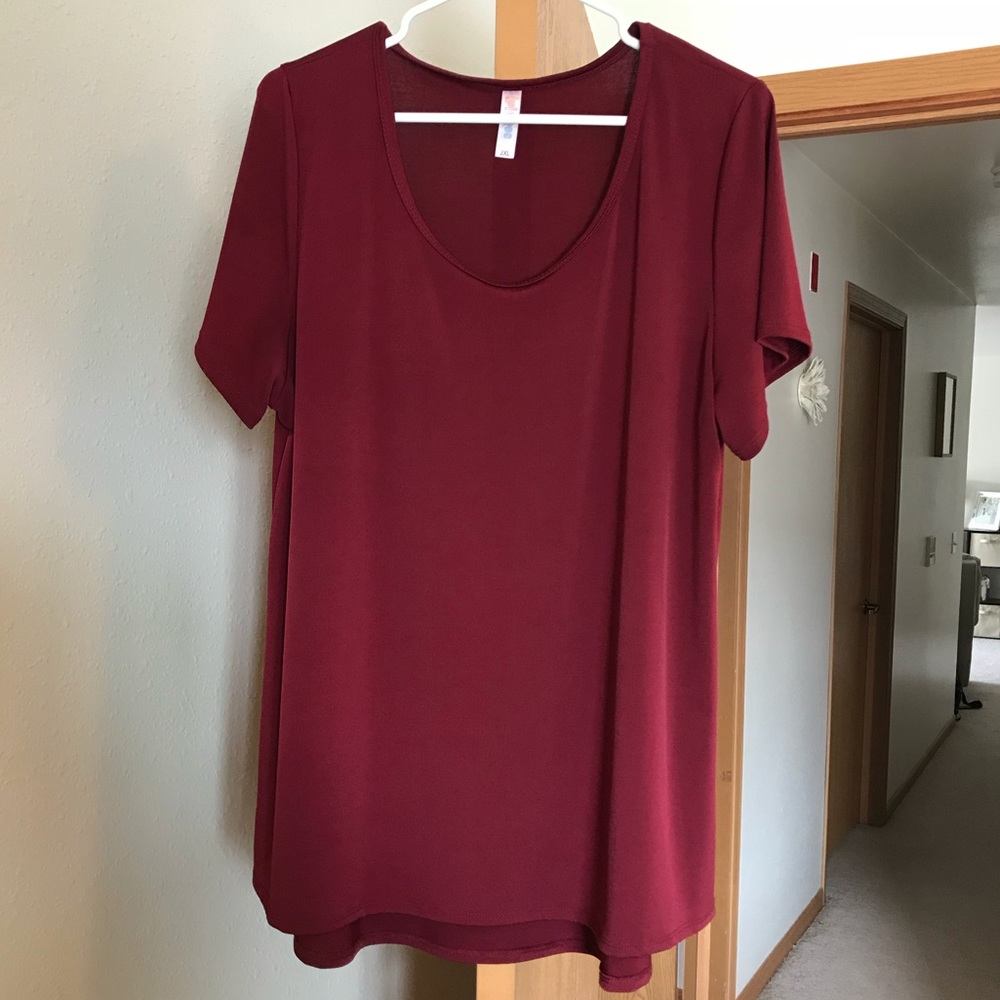 Red, silky type textured blouse.